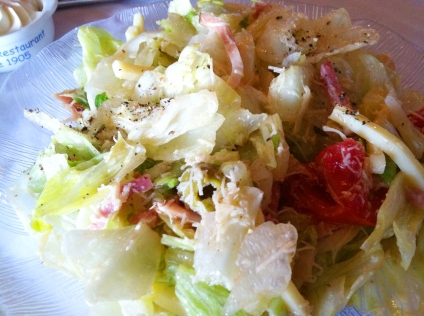 1905 Salad with julienne sliced ham, cheese, tomatoes, green olives, grated romano cheese and tangy garlic dressing.